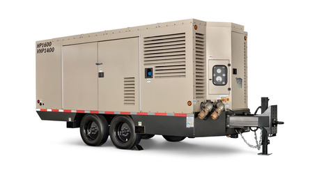Tan and black mobile diesel air compressor ready for repairs in Calgary